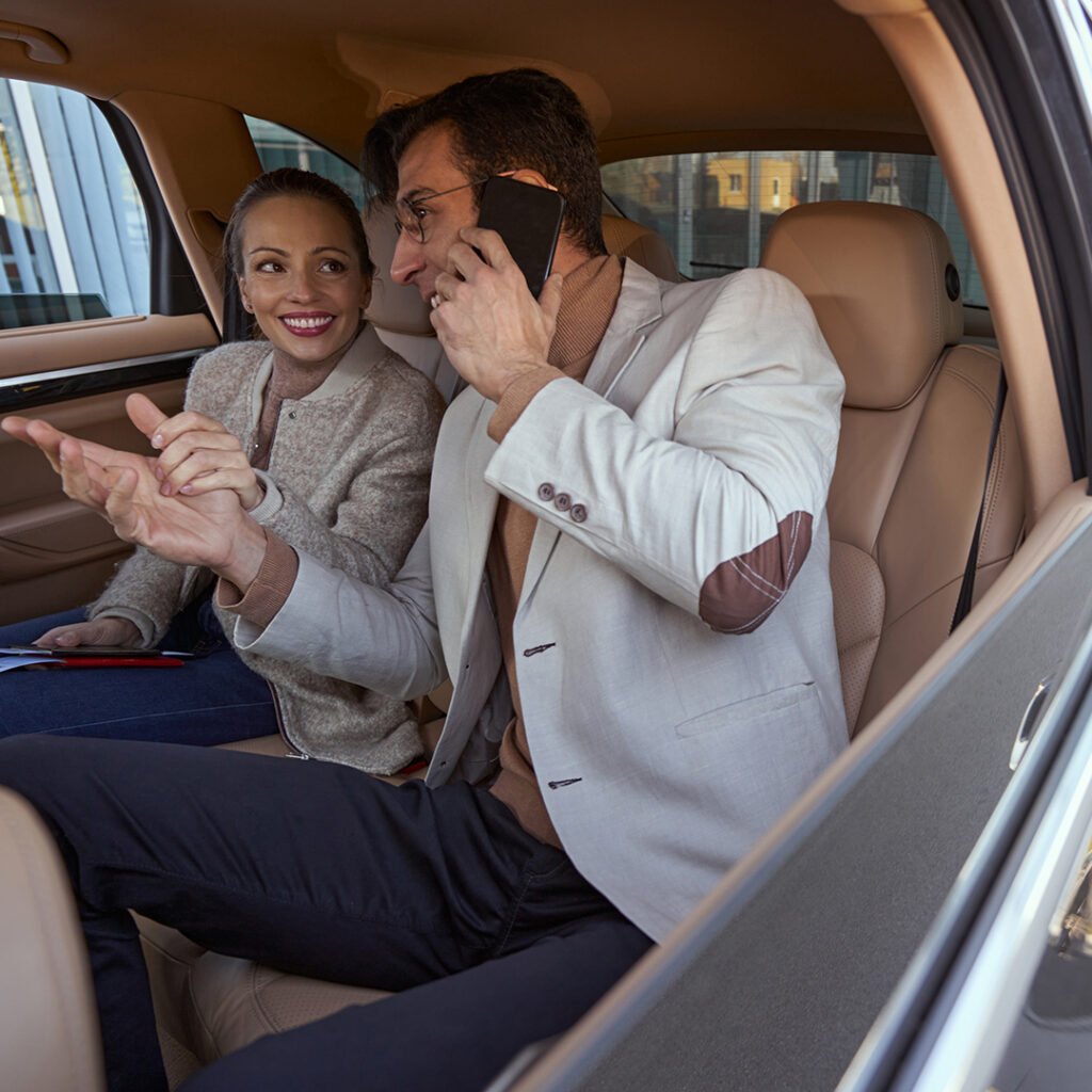 Couple enjoying San Francisco airport limo service, discussing plans in a luxury vehicle while en route to downtown. SFO limo